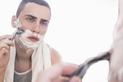 Man shaving in a mirror